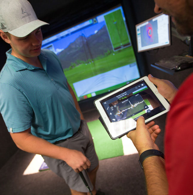 Students in a golf simulation room