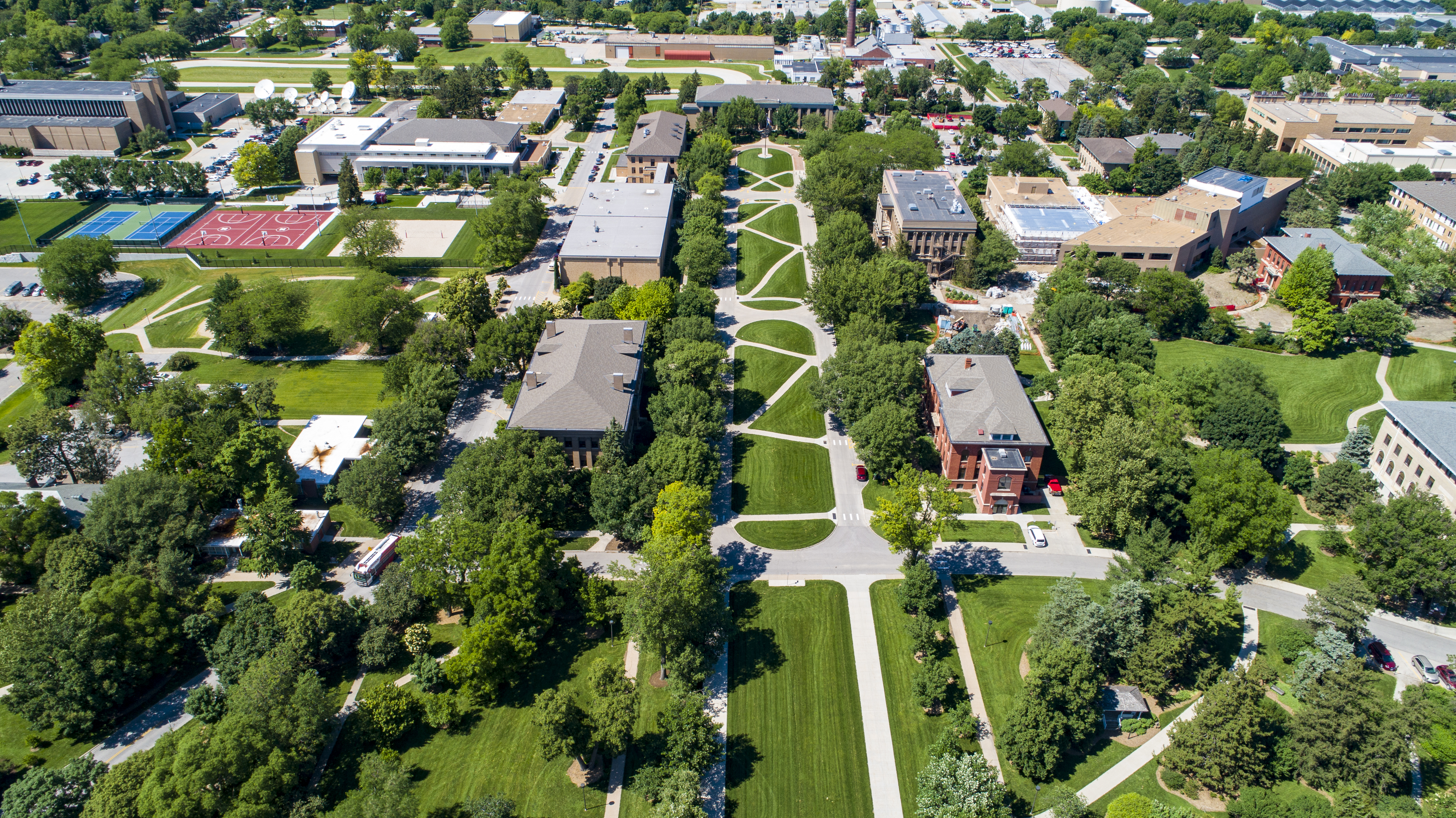 Drone footage over East Campus captures green grass and trees during the summer