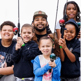 Elijah Riley and kids with fishing poles