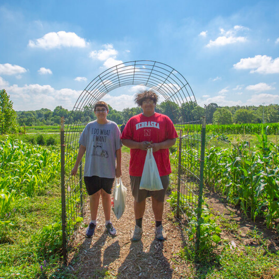 Brothers Gabe and Mateo Perales work in the Indigenous Garden on East Campus.