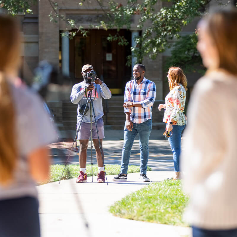 Faculty showing students how to set up photoshoot