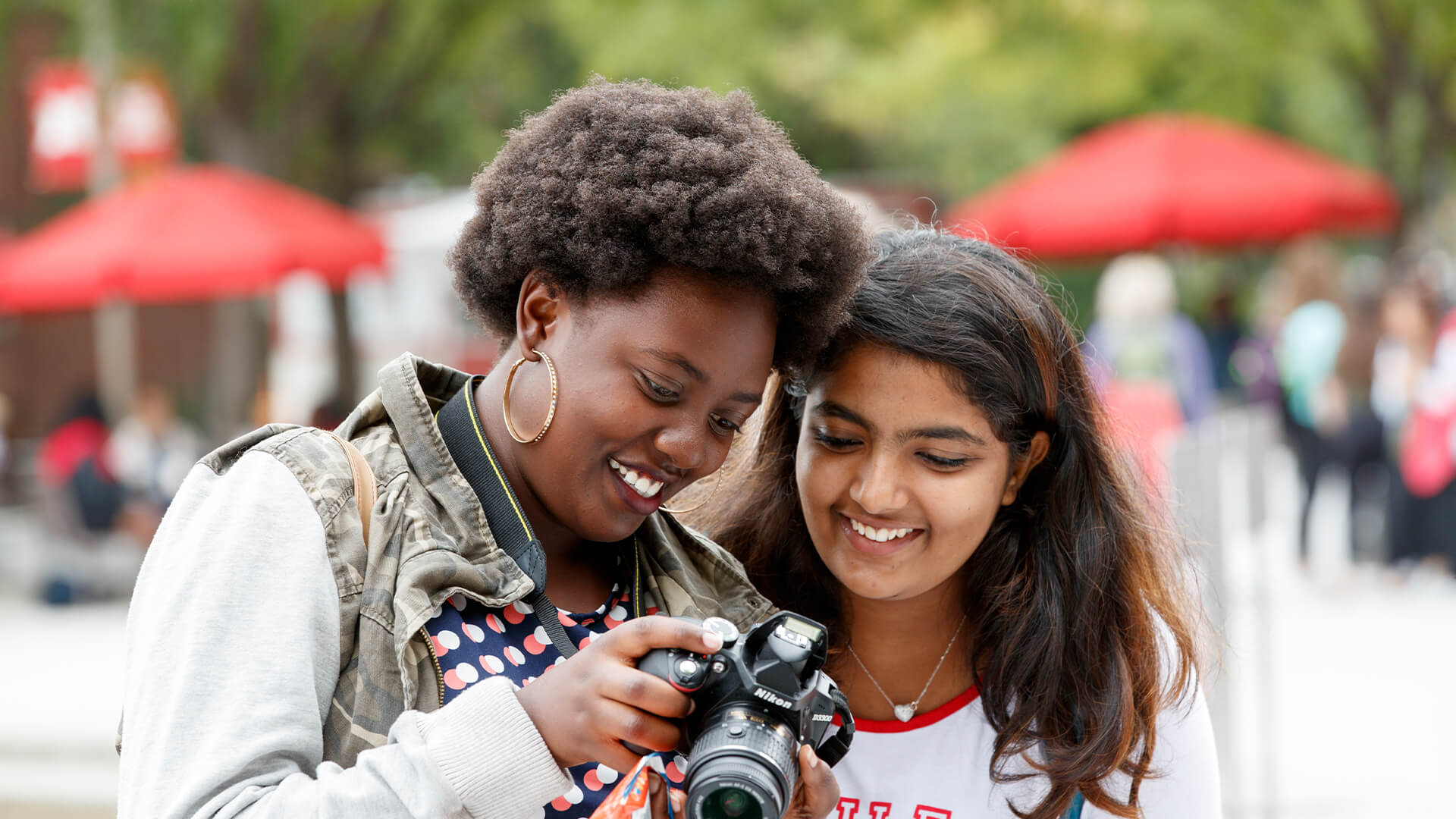 Students looking at viewfinder of camera