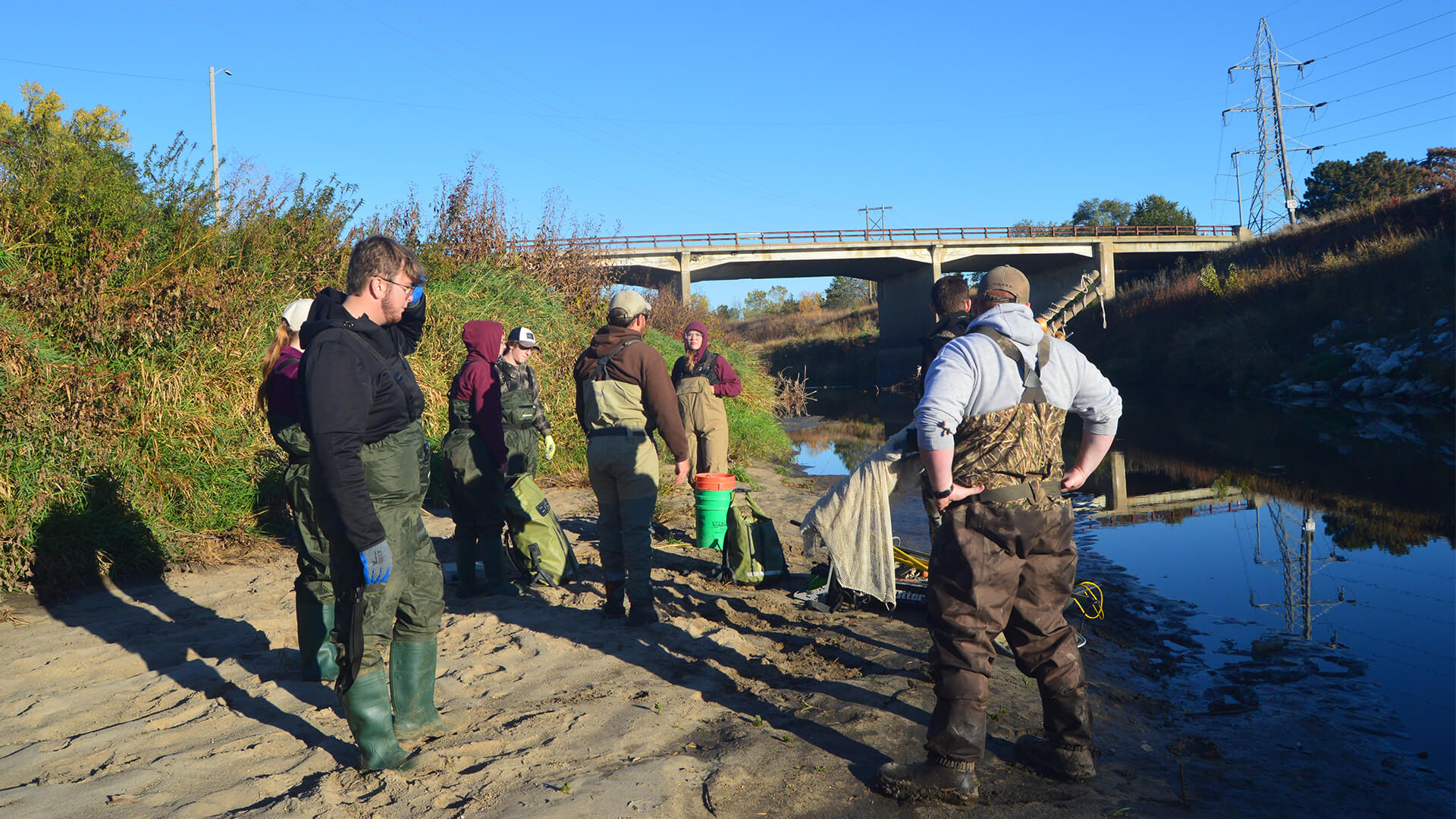 A group of students are near a stream to do research