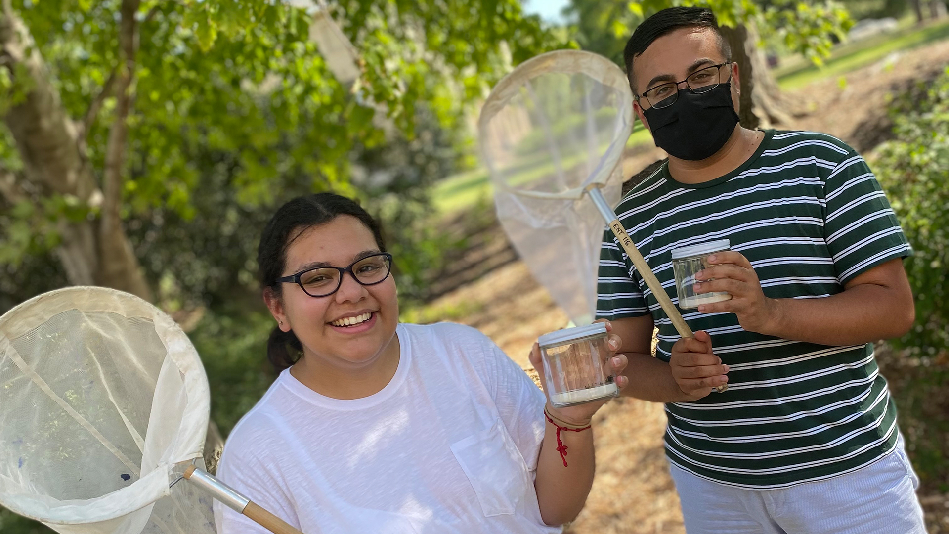 Students holding insect nets