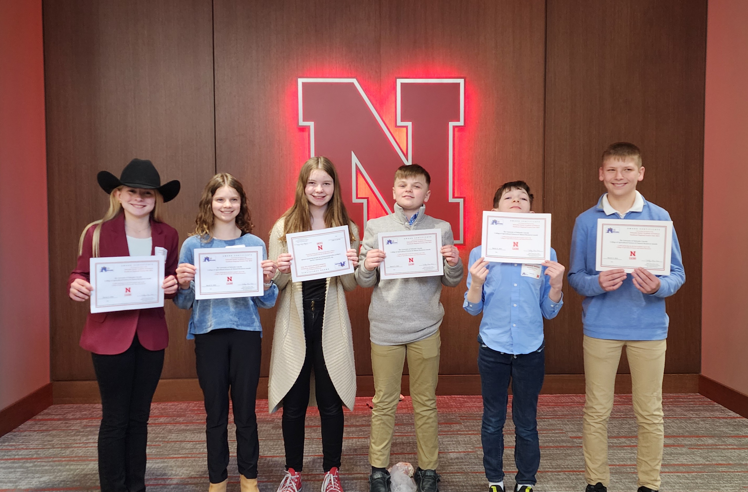 Junior high students pose with their science fair certificates