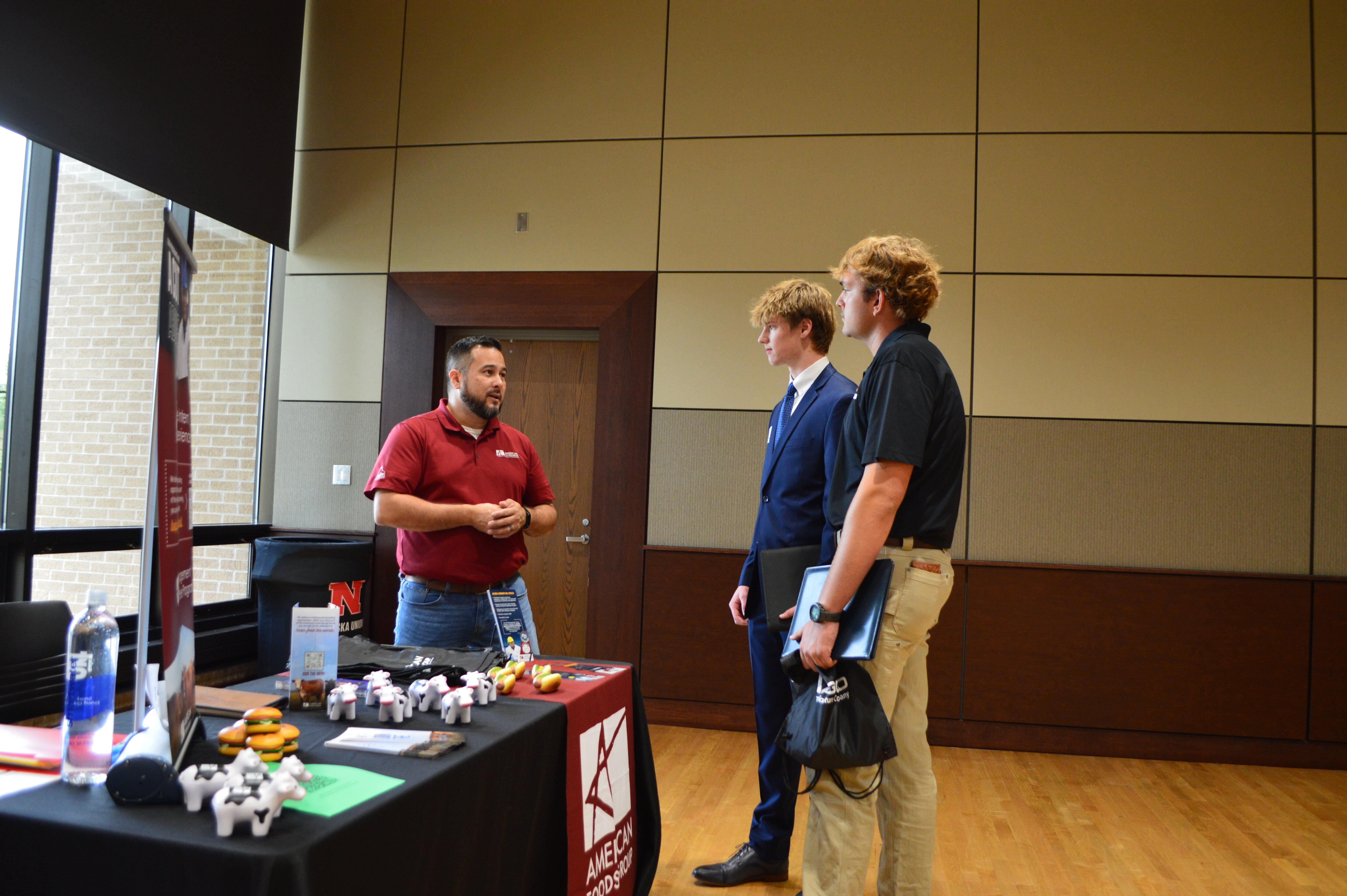 An employer talks to two students at the Fall 2024 Career Fair