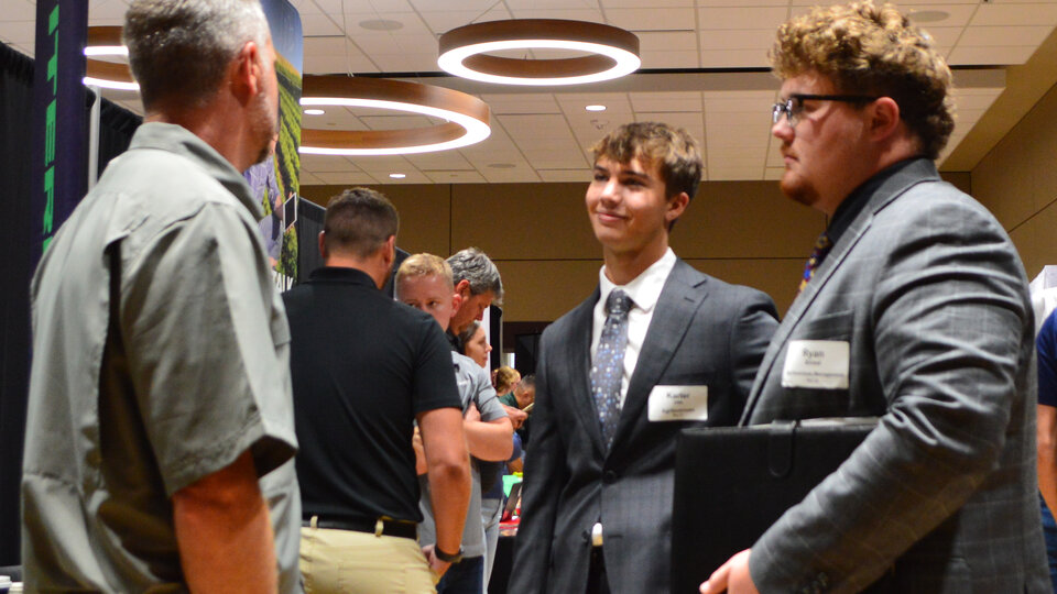 Two students talking to an employer during the fall 2024 career fair.