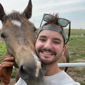 Student posing with horse