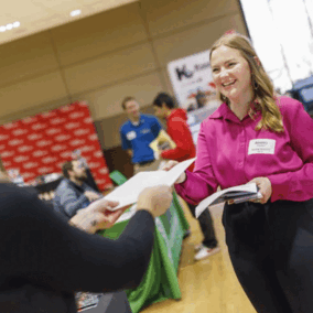 Student handing resume to employer at career fair