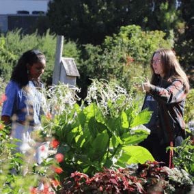 Christine Barta with student in Backyard Farmer Garden