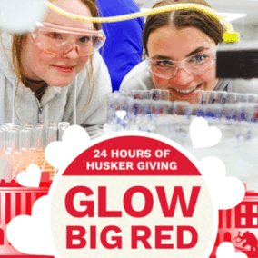 Glow Big Red logo with 2 students in a lab