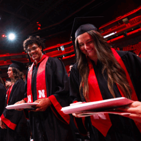 students holding diplomas at graduation