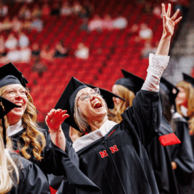 Student waving at UNL graduation 2026