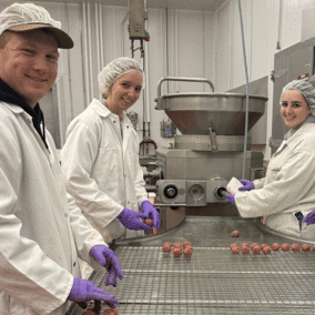 Instructor and students working in the Loeffel Meat shop