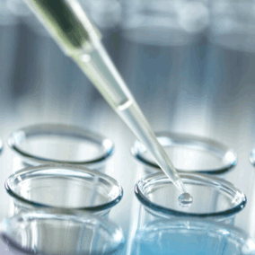 Pipette putting liquid into a glass tube