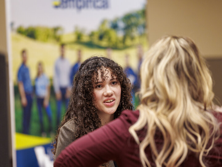 A student talks with an employer at the Spring 2024 career fair