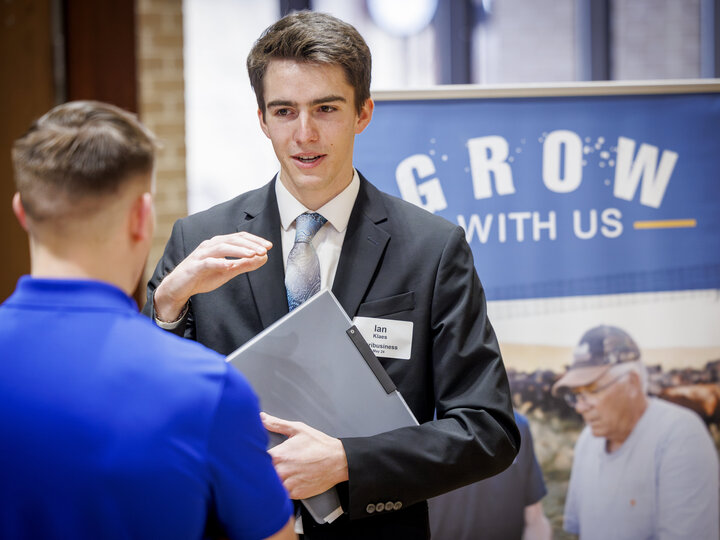 A student talks with an employer at the Spring 2024 career fair