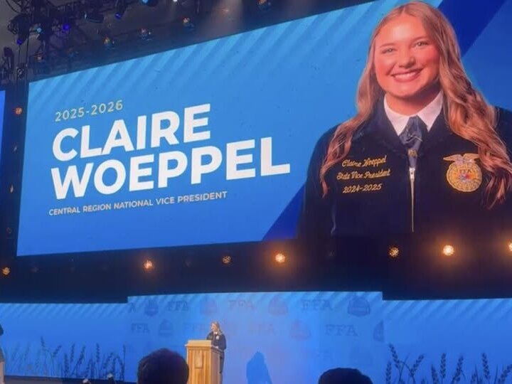 Claire Woeppel approaches the podium at the 2025 National FFA Convention