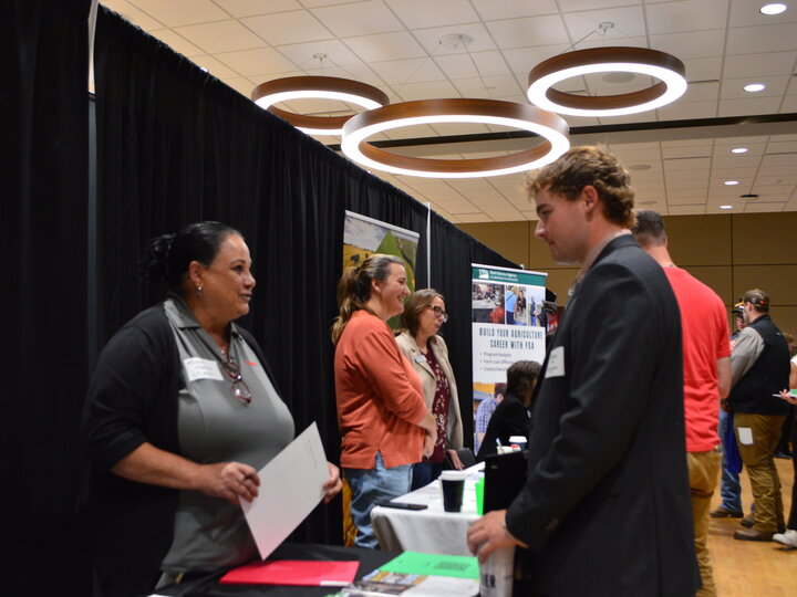 Employer and student talking at the Fall 2024 East Campus Career Fair