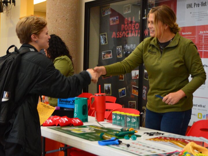 Student shaking the hand of an employer