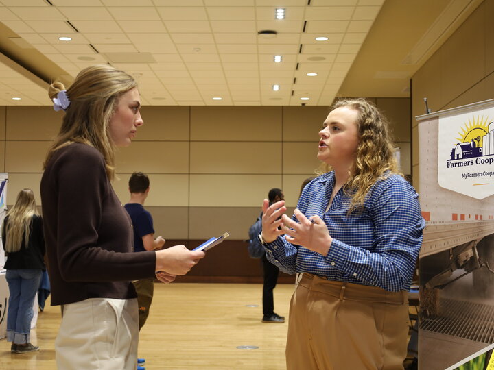A student talks to an employer at the Spring 2026 career fair on East Campus.