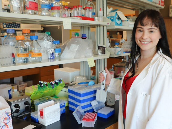 Lauren Wilson holds a pipette in the plant pathology lab