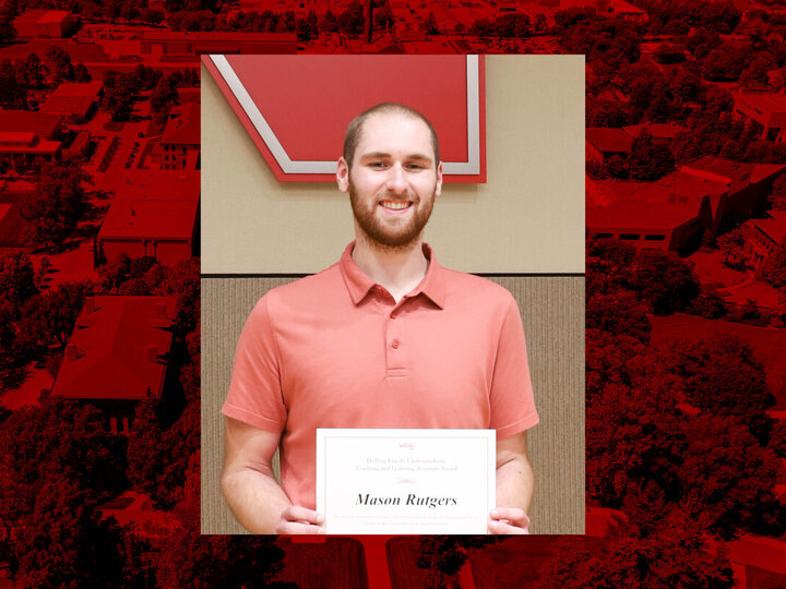 Mason Rutgers posing with a certificate for an undergraduate teaching assistant award