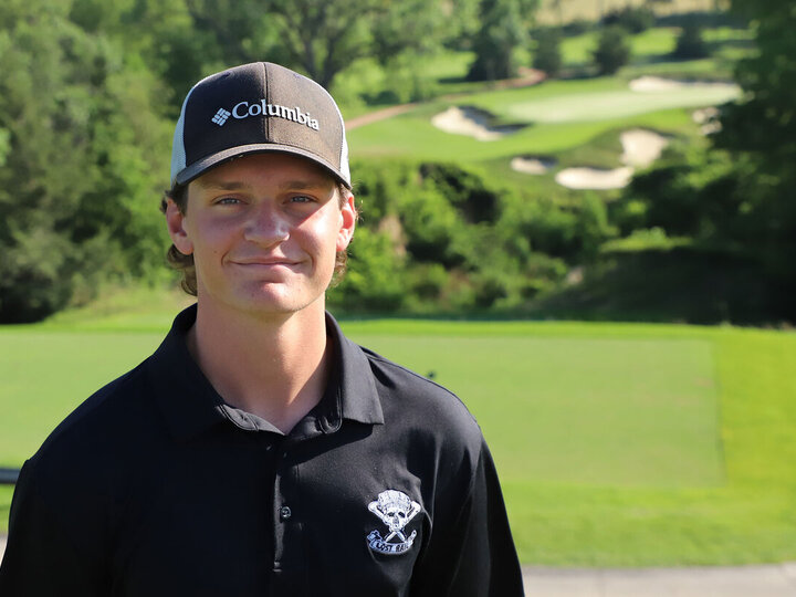 Nate Agosta poses on the course of Lost Rail private golf club.