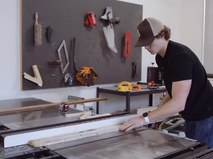 Student cutting a board in the Nebraska Innovation Studio