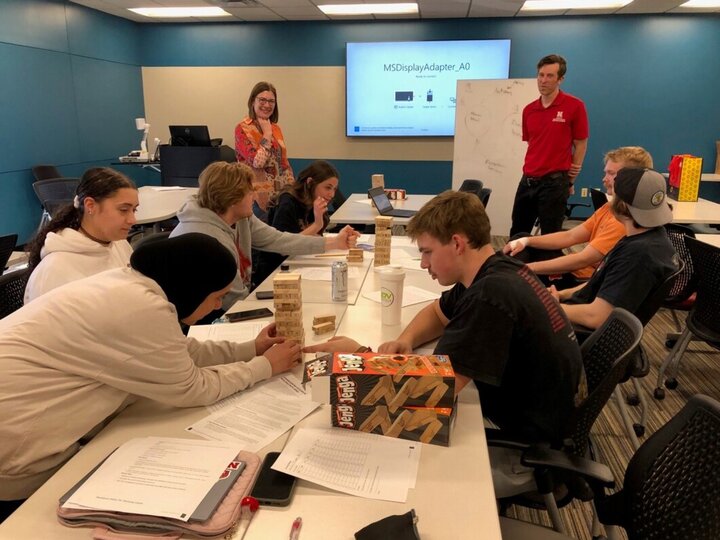Students playing with Jenga in a classroom