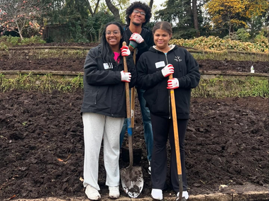 Members of NRHH pose for a photo with shovels after helping Parks & Rec dig up flower beds in the Sunken Gardens