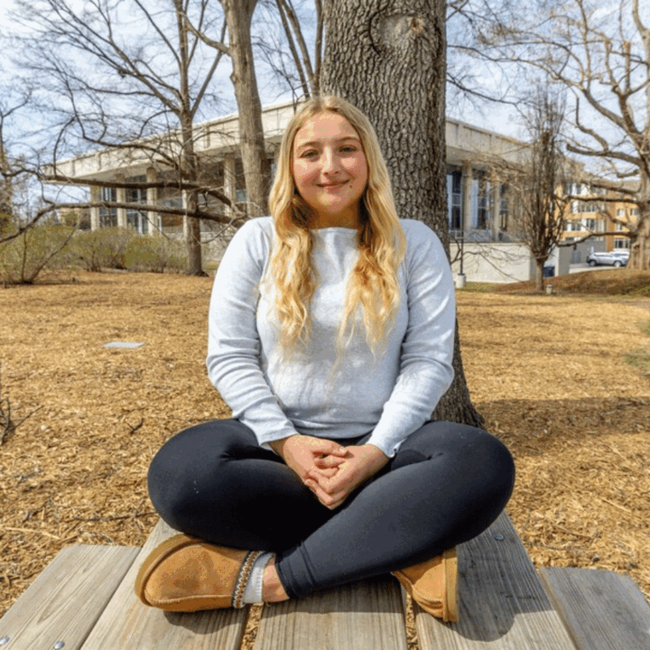 Hannah Haun sitting on a picnic table on East Campus
