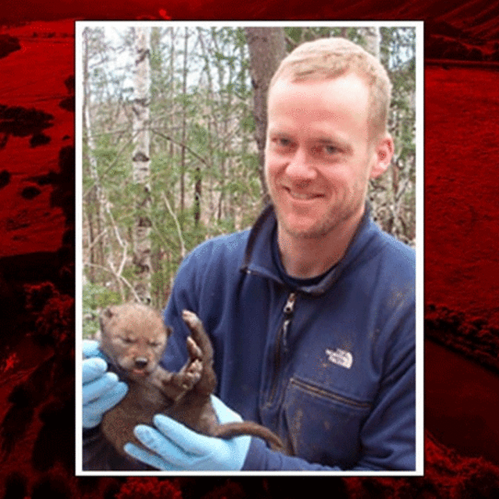 John Benson holding a small otter