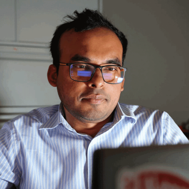 Nipuna Chamara looking at a laptop computer screen